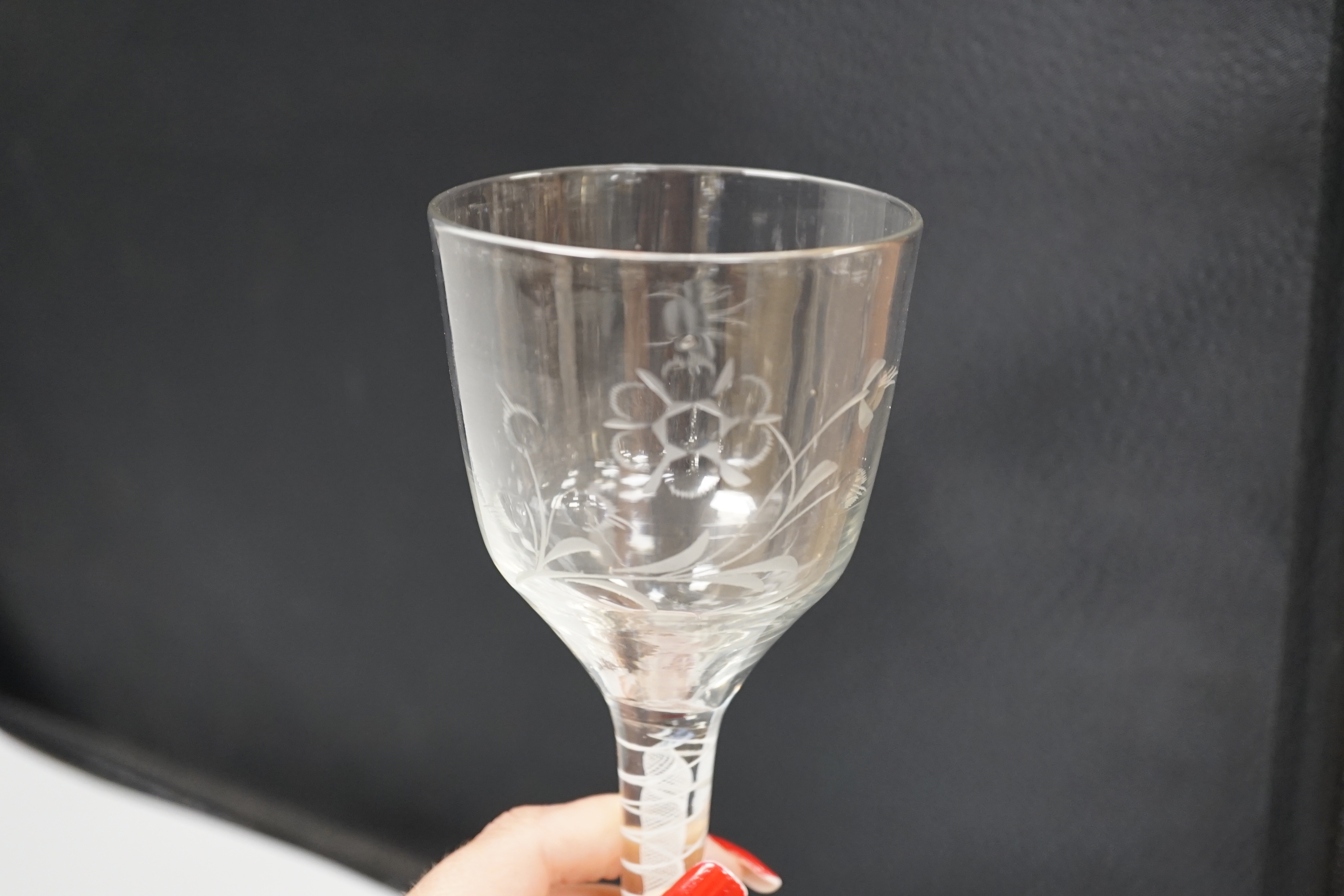 An English lead crystal DSOT goblet, c.1760, ogee bowl with tool marks and engraved with polished flora opposite a single insect which appears to be a bee, two spiral tapes around a gauze, conical foot, broken pontil, 18